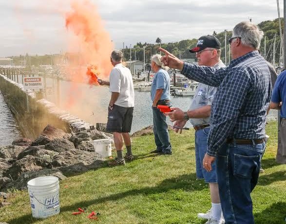 Members practice shooting flare guns and lighting flares at our annual picnic