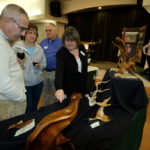 Nila shows her driftwood sculptures to the Rohners
